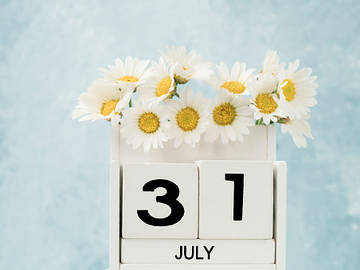 31 july on a box filled with yellow flowers